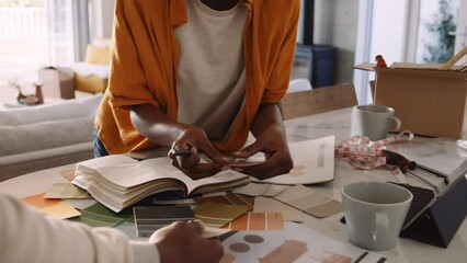 A Black Woman Choosing Paint Swatch Colors with Her Husband