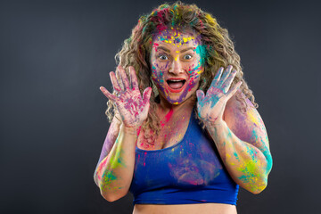 Bodypainting, creative makeup, bright colorful body art on gray background, happy plus size fat woman painted with powder paints