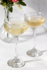 Champagne in glasses on a white background. Hard light
