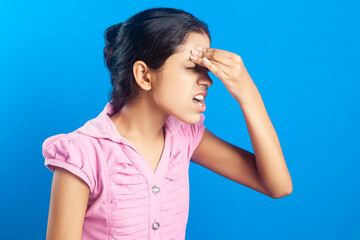 Side view of an Indian teenage girl having headache, shouting due to pain