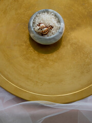 Sea salt in a gray plate on a golden tray. Copy space. Top view