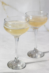Champagne in glasses on a white background. Hard light