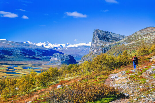 Hiker in a mountainous autumn landscape at Sareks National Park in Sweden