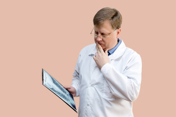 The doctor examines the X-ray picture doctor blond 40-44 years old,