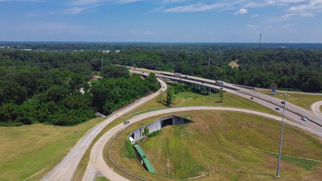 Circular highway exit or ring road with railroad tunnel, large drainage system, overpass, viaduct off highway interstate 20 in Vicksburg, Mississippi