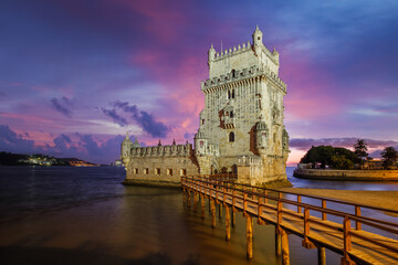 Belem Tower or Tower of St Vincent - famous tourist landmark of Lisboa and tourism attraction - on the bank of the Tagus River (Tejo) after sunset in dusk twilight with dramatic sky. Lisbon, Portugal