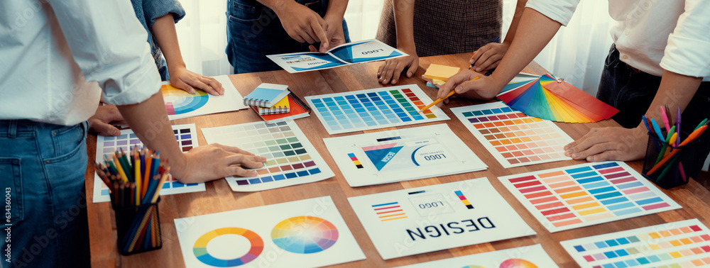 Aufkleber Graphic designer brainstorm logo and graphic art at busy creative studio workshop. Experiment and brainstorm color palette and pattern at workspace table for creative design. Panorama shot. Scrutinize