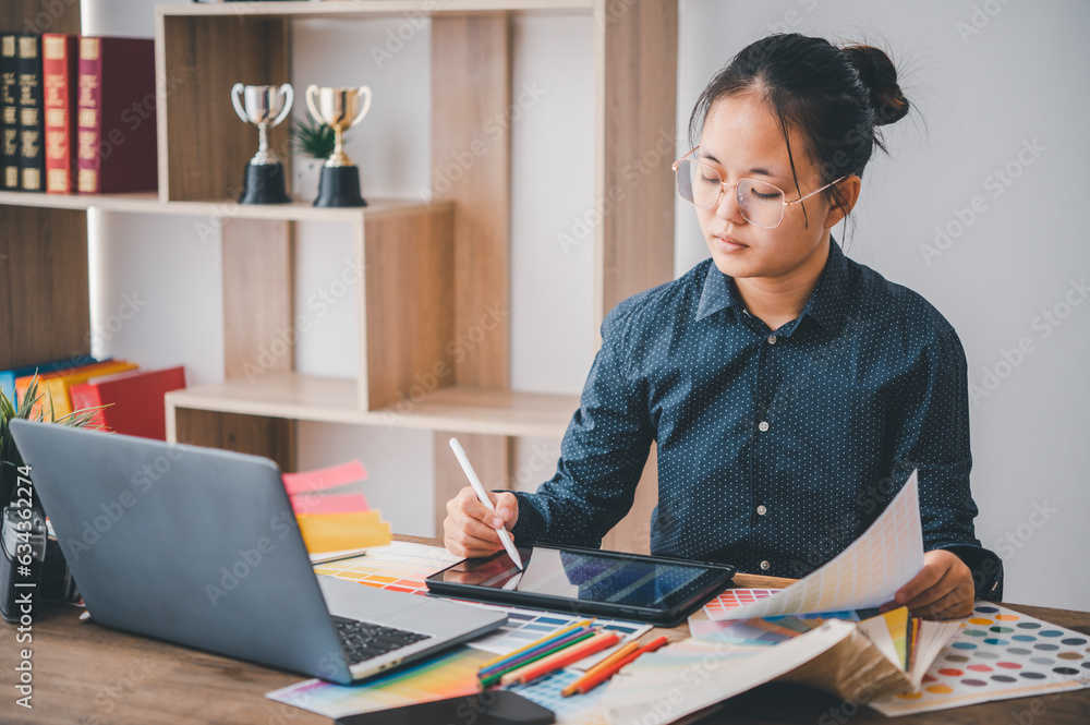 Poster graphic designer architects who work with laptops and color comparison tables for design work..