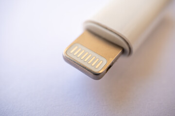 isolated shot of lightning charging cable input on white background, Front shot of charging cable...