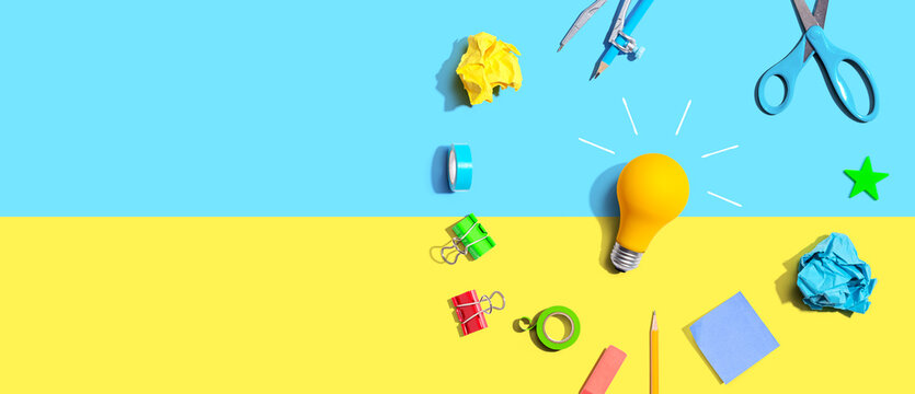 Idea light bulb with school supplies overhead view - flat lay