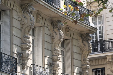 Obraz premium Fancy ornament details and decorations shot on Paris building facades. Doors and windows surround, decorated balconies.