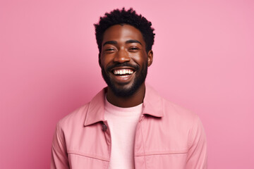 Joyful African American Man with a Playful Expression on Vibrant Pink Studio Background