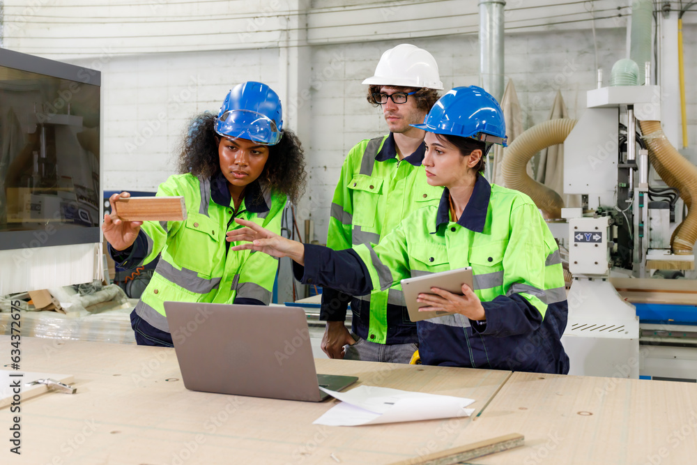 Aufkleber portrait of a team of uniformed male engineers operating a machine with a laptop computer. in the fu
