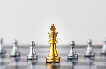 Leader, business strategy and planning concept, Gold Chess king figure on Chessboard and surrounded by a number of fallen silver chess pieces against opponent or enemy. Conflict, tactic, politic.