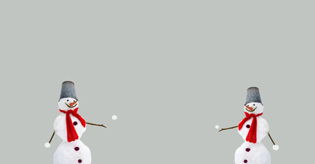 Winter, Christmas-themed composition with a snowman and snowballs. Light background. Copy space. The expression of a smile and playfulness. Minimalism