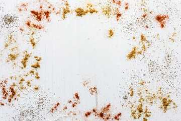 An abstract collage of spices with copy space in the middle.