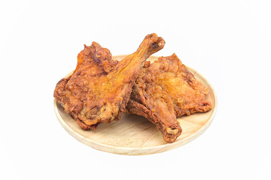 two fried chicken in wooden round tray on white background closeup,isolated