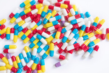 Multicolored tablets lie on a white background. 