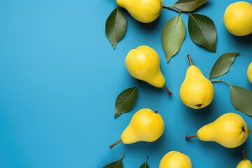 top view of yellow pears on a blue background, fruit harvest, autumn still life, copy space on left side