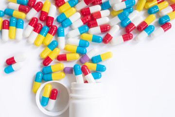 Assorted pharmaceutical medicine pills and capsules and bottle on white background. Copy space for...