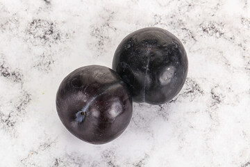 Two ripe sweet black plums