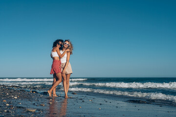 two girlfriends in love walk on the sand on the beach holding hands vacation rest sea summer love