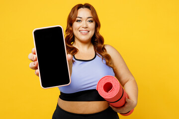 Young chubby plus size big fat fit woman wear blue top warm up training hold yoga mat use show...