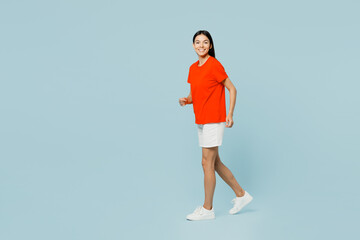 Fototapeta na wymiar Full body smiling happy cheerful young latin woman wear orange red t-shirt casual clothes hold hands crossed folded look camera isolated on plain pastel light blue cyan background. Lifestyle concept.