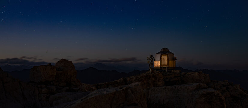 banner or refuge by night on top of alps mountain Italy, sky with star,  panorama, long exposure