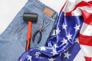 Jeans with tools and USA flag on white background. Labor Day celebration