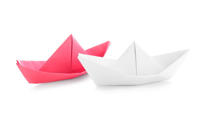 Colorful origami boats on white background