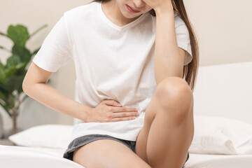 Flatulence ulcer, asian young woman, girl hands in belly, stomachache from food poisoning,...
