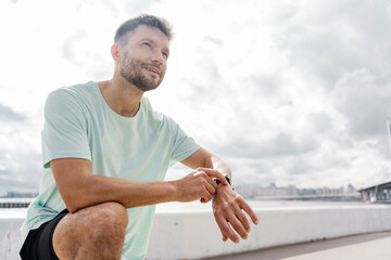 Runner trainer in fitness clothes T-shirt, running sports shoes and smart watch for sports.    A...