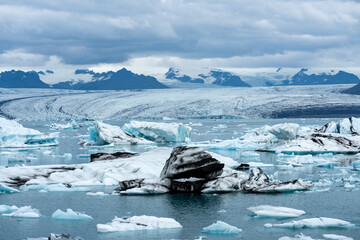 Jokulsarlon glacial lake in Iceland, chunks of blue icebergs, cold landscape in Europe