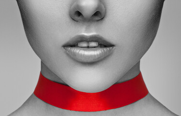 Beautiful woman with clean skin and pink makeup, with closed eyes with a red ribbon on her neck. ...