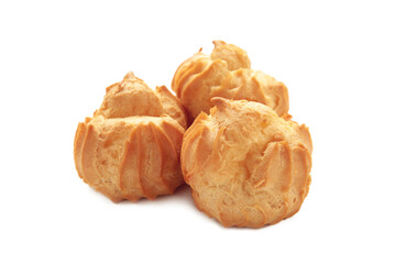 Homemade profiteroles with cream isolated on a white background. Fresh baked golden profiterole.