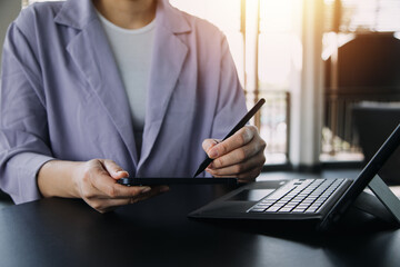 Asian Business woman using calculator and laptop for doing math finance on an office desk, tax, report, accounting, statistics, and analytical research concept