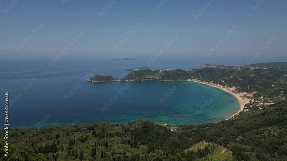 Wall mural Drone aerial footage of Agios Georgios Beach, featuring its turquoise waters and sandy shoreline, set against the charming backdrop of rolling hills