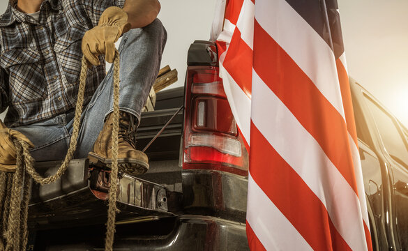 American Rancher with a Rope Seating on His Pickup Truck Bed