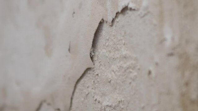 The wall, which is moistened by water and cracked paint, rotten wall surface due to moisture,