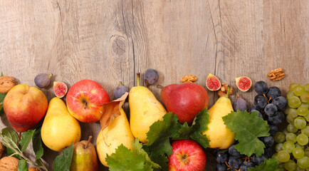 pear, apple, grapes and fresh fig composition with leaves- autumn food concept