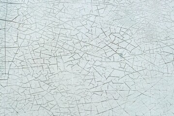 A surface cracked paint on the wall of an old building, abstract texture and background