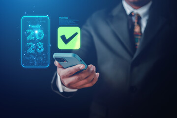 businessman uses technology to take online checklist survey Mark checklists and complete online forms. Question answer concept. Assessment. 2023 Online survey.	
