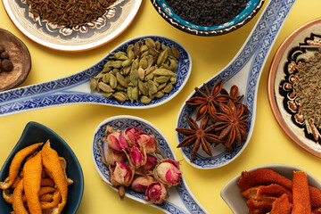 Various spices: damask rose, star anise, cardamom and others. Top view.