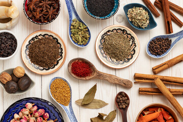 Fototapeta na wymiar Various spices: damask rose, cinnamon, star anise, cardamom, dried limes and others. Top view.