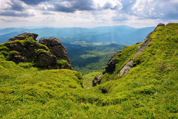 Fototapeta premium summer mountain landscape. rocks on the grassy hills. beautiful scenery on a sunny day