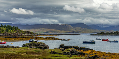 Fototapeta na wymiar Landscape, lochs and mountains with moody and atmospheric skies on the Isle of Skye, Scotland 