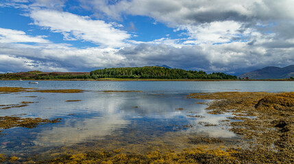 Landscape, lochs and mountains with moody and atmospheric skies on the Isle of Skye, Scotland 