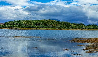 Landscape, lochs and mountains with moody and atmospheric skies on the Isle of Skye, Scotland 
