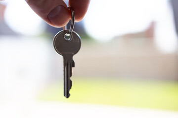 House key in the hand at blurred background
